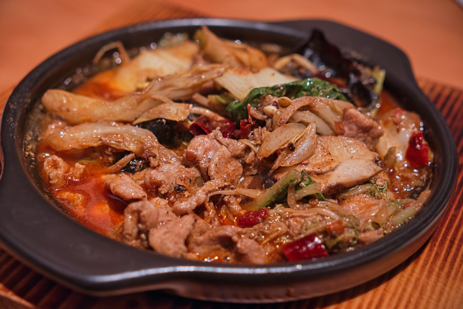 Family enjoying a shared Chinese dinner at Evergreen On 38 in Midtown Manhattan with a variety of dishes on the table.