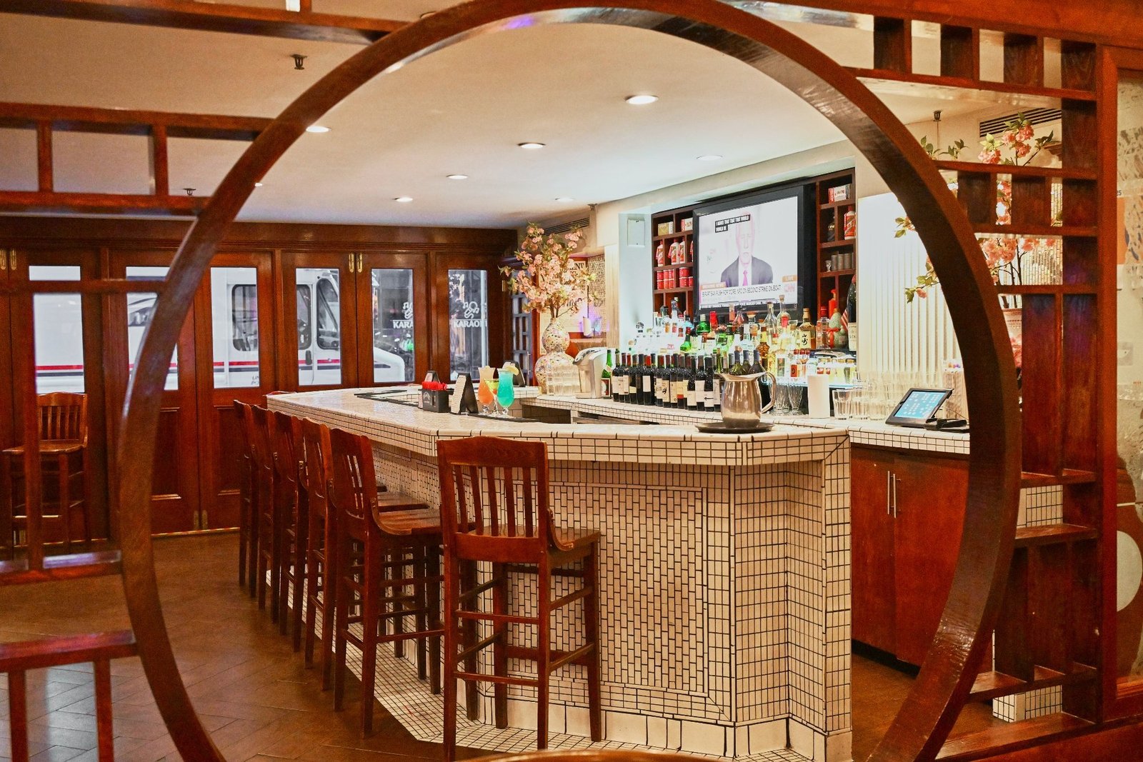 Bar area at Evergreen On 38 viewed through a traditional moon-gate doorway