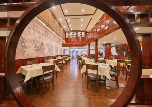 Dining room at Evergreen On 38 with a hand-painted mural wall