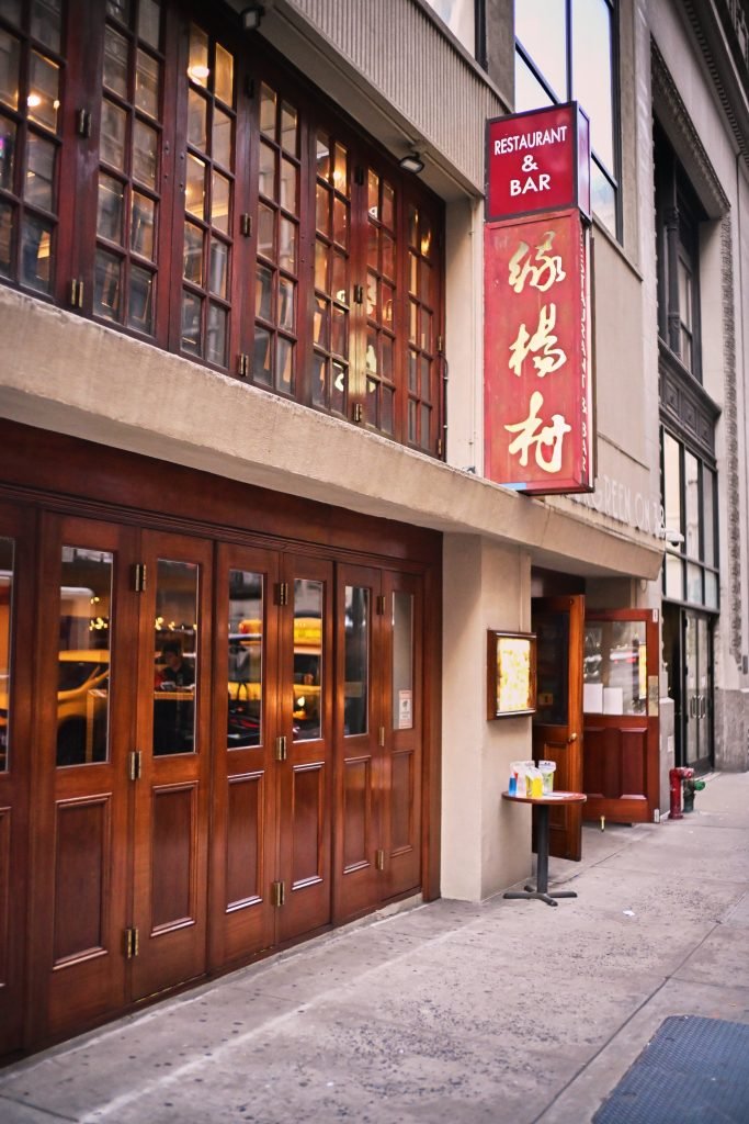Evergreen On 38 restaurant entrance with wooden doors and signage in Midtown Manhattan