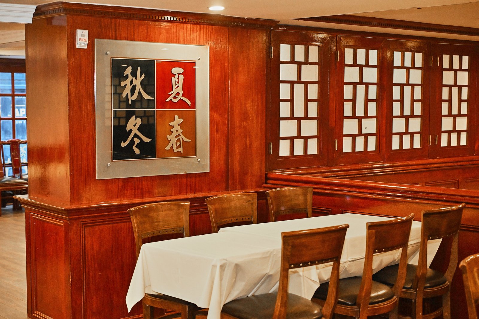 Seasonal calligraphy wall art in the dining room at Evergreen On 38