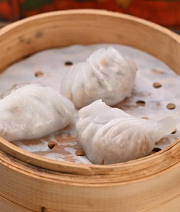 Steamed dumplings in a bamboo steamer basket
